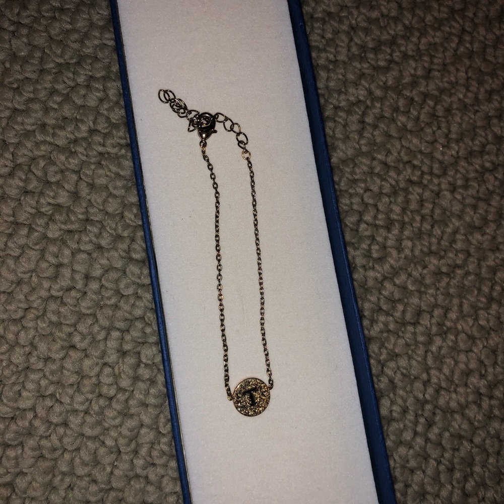 Gold bracelet with T charm